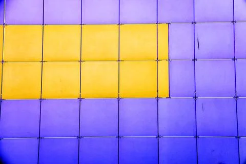 The outer wall of the building is finished with framed plastic tiles, the c.. Ilustración de archivo