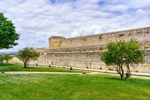 Outer wall of the castle of Zamora in front of the park of green grass and Stock Photos