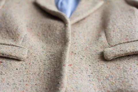 Outerwear, front view.Women's jacket made of boucle fabric with two pockets. Stock Photos