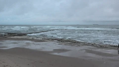 Outfall pipe in grey sea with small waves Stock Footage 260503579