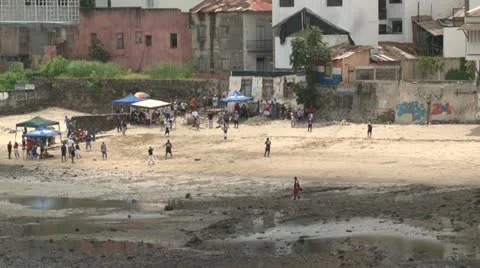 Outfielder splashes through low tide during baseball game on Casco Viejo beach Stock Footage 12008611