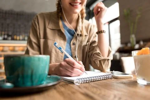 Outgoing girl making notes in scribbling-diary Stock Photos