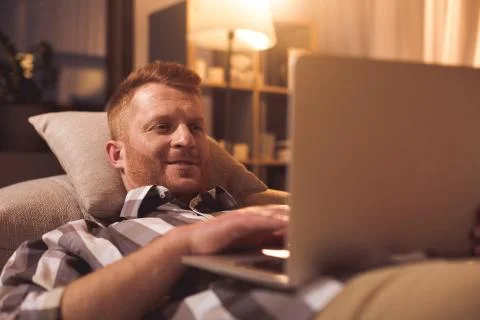 Outgoing male resting with notebook computer Stock Photos