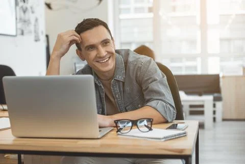 Outgoing male using notebook computer Stock Photos