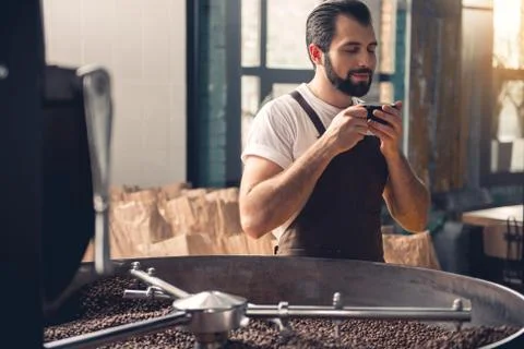 Outgoing worker tasting mug of liquid Stock Photos
