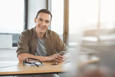 Outgoing worker typing in mobile Stock Photos