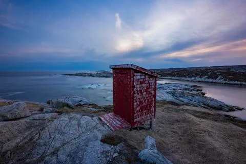 Outhouse at sunset on the rocky coast of Newfoundland Stock Photos