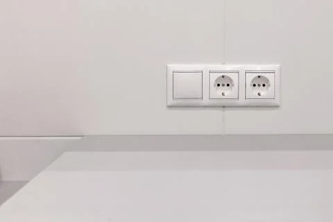 Outlet with a switch on the wall Stock Photos