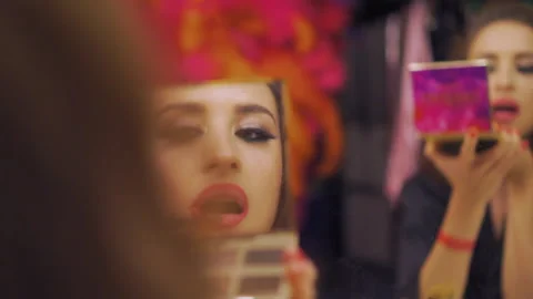 The outline lips makeup in double-mirror reflected. The girl outlines contours Stock Footage 220469814