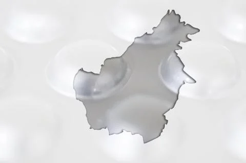 Outline map of borneo with pills in the background for health and cure Stock Photos