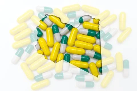 Outline map of libya with pills in the background for health and cure Illustrazione stock