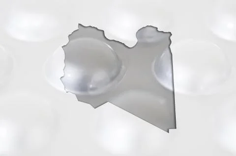 Outline map of libya with pills in the background for health and cure Stock Photos