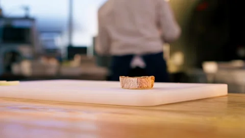 Outline of a piece of fried bread on a white board in professional kitchen Stock Footage 273534452