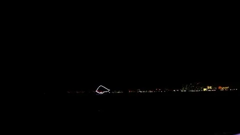 Outline of pirate ship sailing close to bay at night, city skyline Stock Footage 78112190
