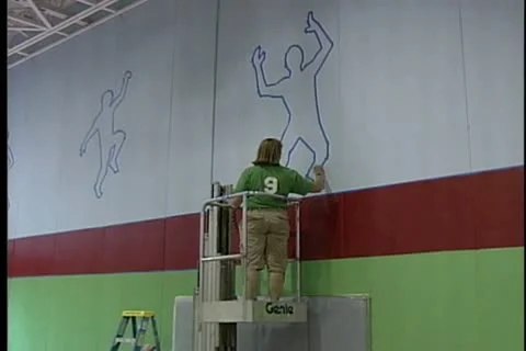 Outlining Poses on Wall for Gym Make-over Stock Footage 10686637