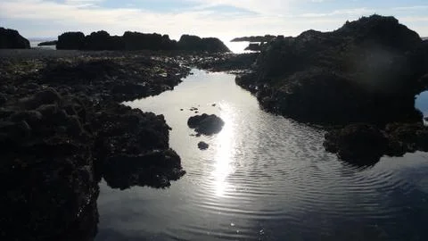 Outlooking rocky cliffs during sunset Stock Photos