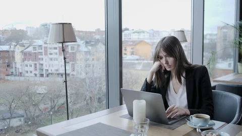 Outraged and seriously reacts. Young woman sitting in coffee shop at wooden Stock Footage 109602105