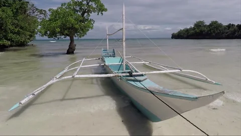 Outrigger boat moored on the sandy beach, Malapascua island, Philippines Stock Footage 246426909