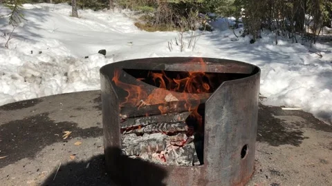 Outside Fire Pit with Fire Burning and Snow in the Background. 스톡 동영상 129128729
