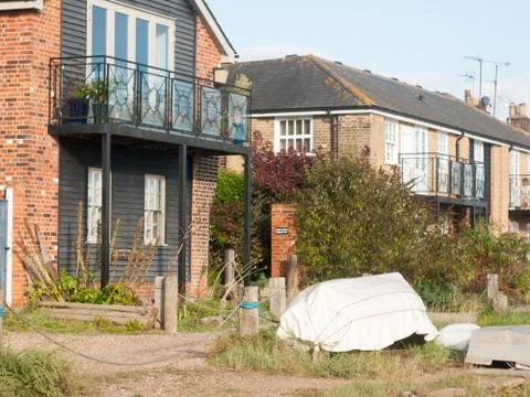 Outside of home down at the seafront balcony and covered boat Stock Photos