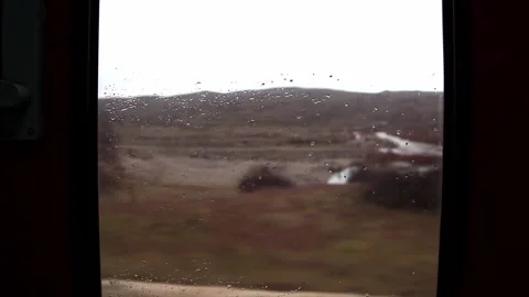 Outside landscape and raindrops on the windshield of a train journey Stock Footage 331358827