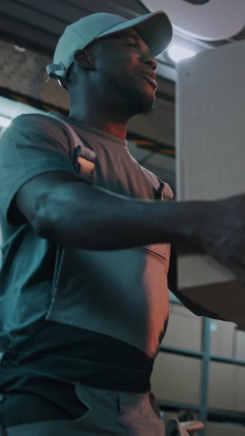 Outside of Logistics Distribution Warehouse at Night: Worker Giving Cardboard Vídeo Stock 313348581