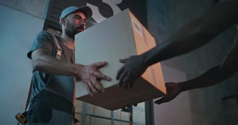 Outside of Logistics Retail Warehouse at Night: Employee Giving Cardboard Box to Vídeo Stock 313342613