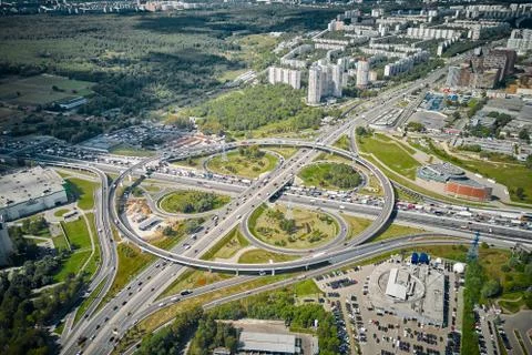 Outside look on intersection. Traffic, residential area and green forest arou Stock Photos