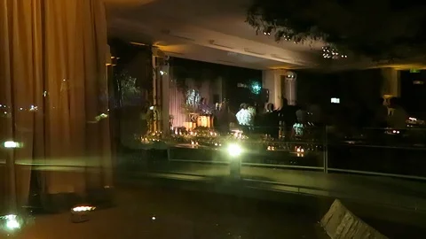 Outside looking in view of wedding with people dancing. Stock Footage 97382996