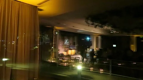 Outside looking in view of wedding with people dancing. Stockbeeldmateriaal 97383426