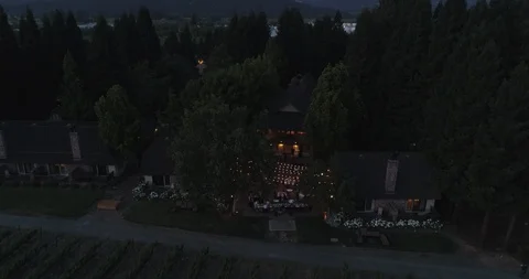 Outside party event by fields at evening dusk. Drone aerial A Stock Footage 111650898