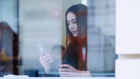 Outside shooting of a beautiful young woman in a stylish look sitting by the Stock Footage