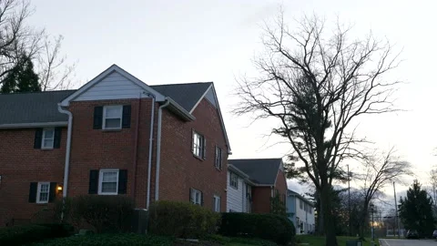 Outside on the side of an apartment complex at dusk 動画素材 144259942
