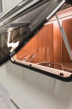 Outside standing and looking through a window of a caravan Stock Photos