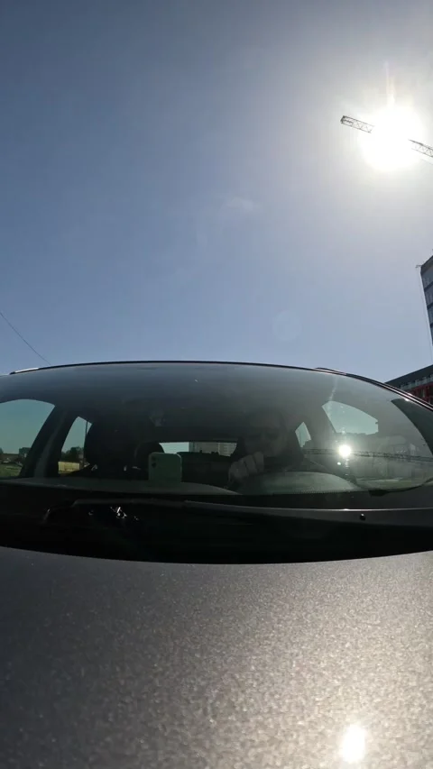 Outside view of man driving car by city time lapse Stock Footage 276348274