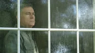 Outside View Of A Man Looking Out A Window During A Rain Storm Stock Footage