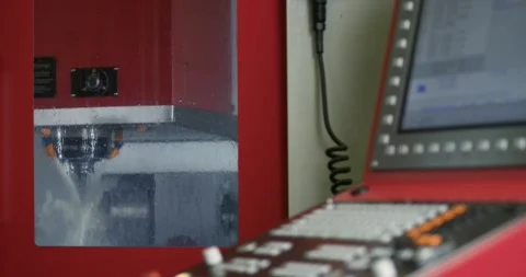 Outside view of a milling machine processing raw metal parts using coolants Stock Footage 311506432
