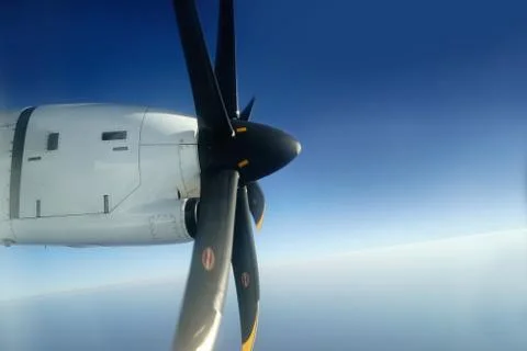 Outside view from window seat of small airplane propeller engine. Stock Photos
