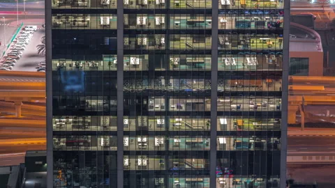 Outside view of windows in offices of a high class building at night timelapse Video stock 167602136