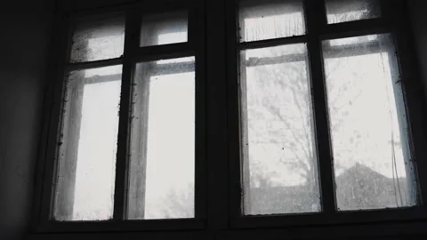 Outside the window in the old house you can see the street with trees Видео 154370809
