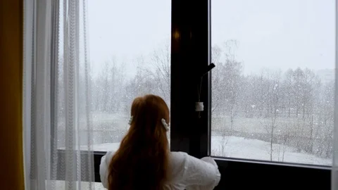 Outside the window, snow is falling and it is snowing.big snow flakes falling Stock Footage 128454052