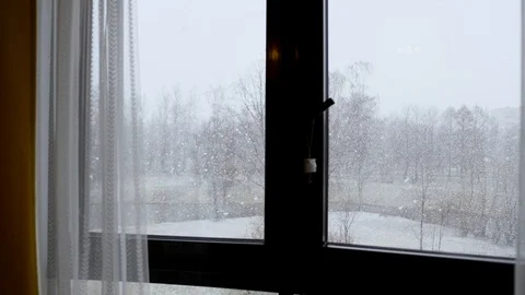 Outside the window, snow is falling  it is snowing.big snow flakes are falling Stock Footage 128453681