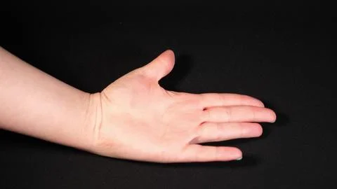 Outstretched female hand top view Stock Photos