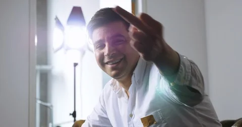 Outtake Studio Shot of Man Smiling and Giving the Middle Finger Stock Footage 120434727