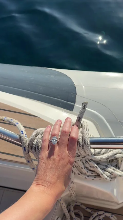 Oval diamond engagement ring captured with luxury yacht details Stock Footage 318335046