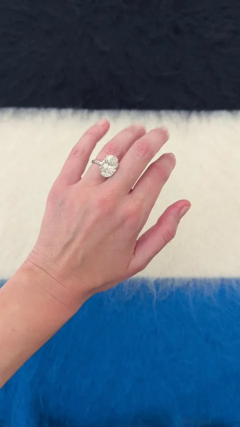 Oval diamond engagement ring on hand clean studio style Stock Footage 328251312