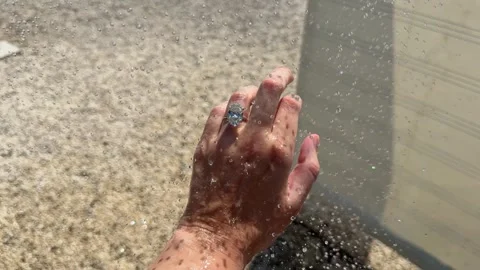 Oval diamond engagement ring sparkling under outdoor shower sunlight Video stock 319450962