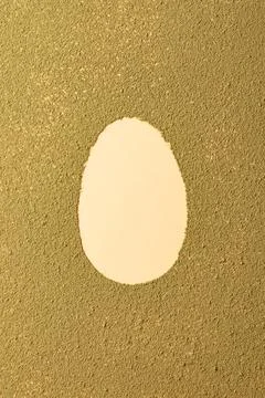Oval easter egg silhouette made from matcha tea on green textured background Stock Photos