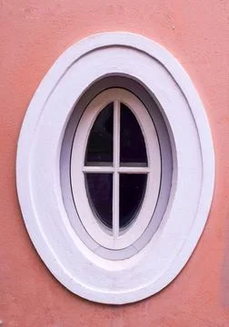 Oval Window with White Frame on a Pink Wall in Tallinn Old Town Stock Photos