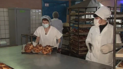 The oven in the bakery. Hot fresh bread leaves the industrial oven in a bakery. Stock Footage 230493555